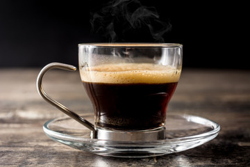 coffee glass and coffee grain on wooden table. 