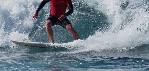 Sports man surfing wave on surfboard in ocean