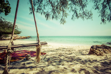 wooden swing in the shade of the beach