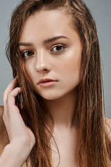 Beautiful portrait of a girl with wet make-up and shiny skin. Perfect Fresh Skin. Pure Beauty Model. Youth and Skin Care Concept