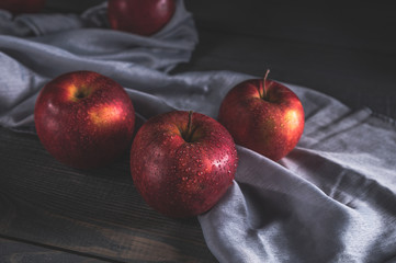 Fresh red apples on wooden table