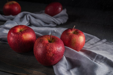 Fresh red apples on wooden table