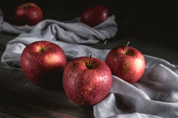 Fresh red apples on wooden table
