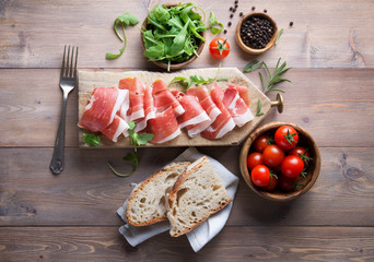 Raw ham, italian prosciutto crudo. Top view, space for text.