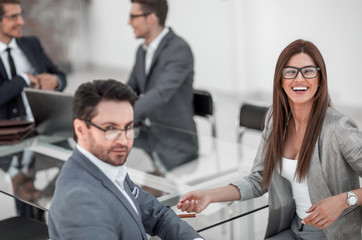 businessman and business woman sitting at office Desk
