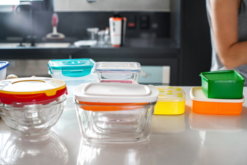 colorful plastic pots on top of kitchen counter
