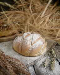 homemade baked bread on grey textile tissue on wooden table