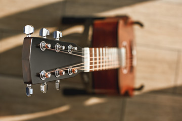 Beauty of musical instrument. Creative top view photo of the brown acoustic guitar with focus on...