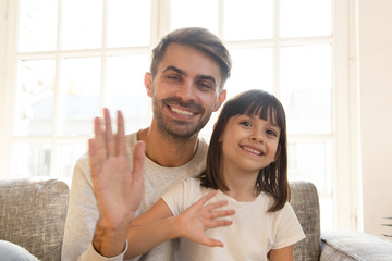 Happy child girl and father wave hands record vlog