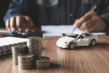 Car insurance and car service. Businessman and toy car for accounting and financial concept.