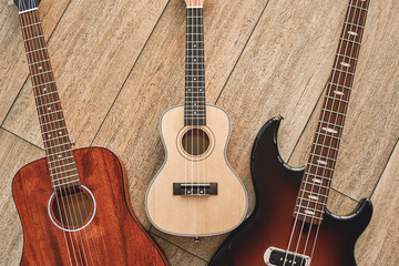 How To Choose Your First Guitar? Top view on three different types of guitars: acoustic, electric...