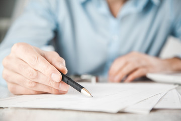 man hand pen with document on desk