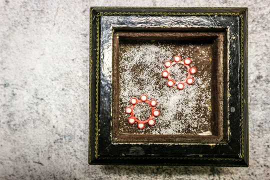 red toy gun caps in black wooden frame on marble table background