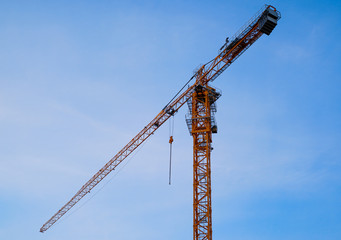 tower crane on blue sky background, isolated