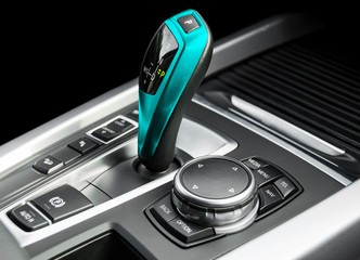 Blue Automatic gear stick of a modern car. Modern car interior details. Close up view. Car...