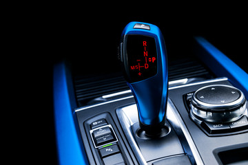 Blue Automatic gear stick of a modern car. Modern car interior details. Close up view. Car...