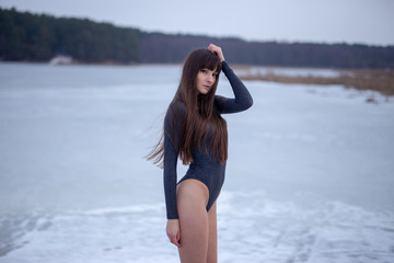 Pretty girl outdoor winter portrait on the ice lake 