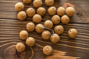 Carp baits on a wooden background.