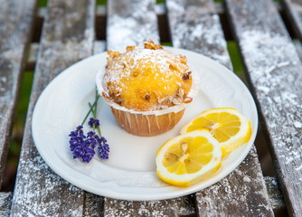 Homemade cupcake with fresh lemon and purple flower
