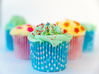 Homemade, colorful cupcakes on white background