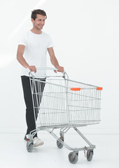 smiling man pushing shopping cart.