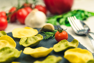 Classic ravioli filled with basilico and cheese on a platter of stone.