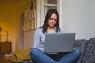 Fototapeta na wymiar woman using laptop at her home