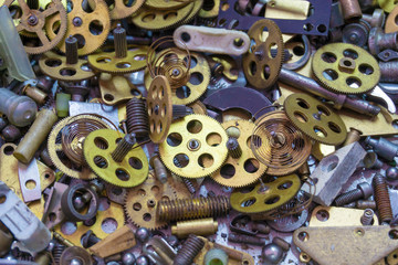 Disassembled clock mechanism in the box, in the metal workshop.