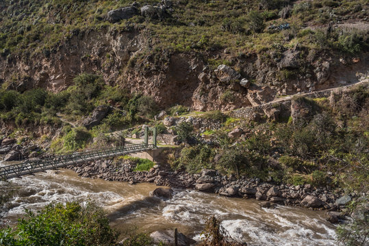 Bridge marking the trail to Machu Picchu along the Urubamba River in Peru