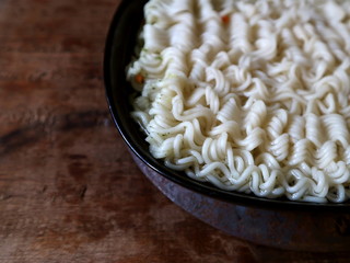 Twisted wavy noodles. Noodles in a black plate.