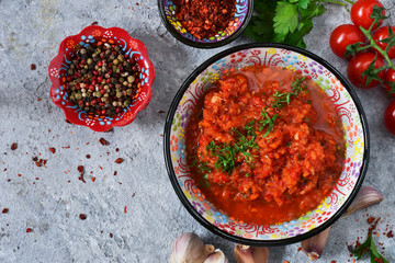 Spicy chili sauce with spices, herbs. Tomato sauce with cilantro.