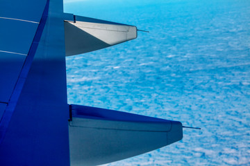 Fototapeta premium airplane flying above blue clouds