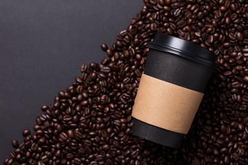 Take away black coffee cup with roasted coffee beans