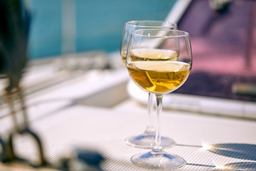 Pair of wineglasses against the yacht