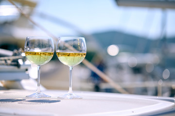 Pair of wineglasses against the yacht