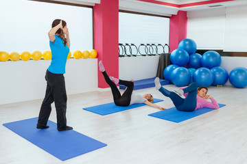 group of young women doing exercises at the gym