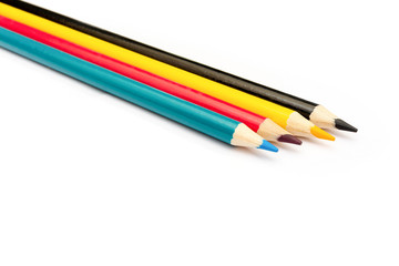 Four colored pencils. The colors cyan, magenta, yellow and black. The concept of polygraphy.