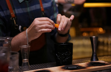 Fototapeta na wymiar Bartender preparing tasty cocktail at counter in nightclub, closeup