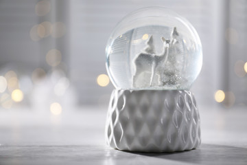 Christmas snow globe on table. Space for text