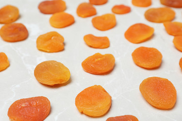 Tasty apricots on grey background. Dried fruit as healthy food