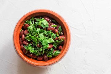 lobio is a Georgian national dish.Lobio,  on white background, view from above.Boiled georgian beans or Lobio in a clay pot 