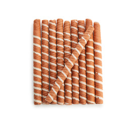 Delicious chocolate wafer rolls on white background, top view. Sweet food