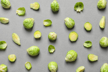 Tasty fresh Brussels sprouts on grey background, top view