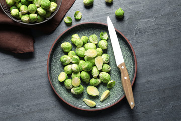 Plate with fresh Brussels sprouts on table, top view