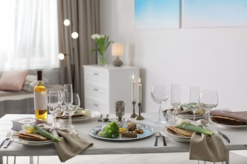 Festive Passover table setting with Torah at home. Pesach celebration