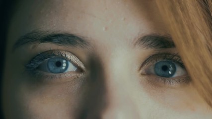 part of young woman face, blue eyes blinking, blur out of focus, natural beauty concept,health, medicine and genes