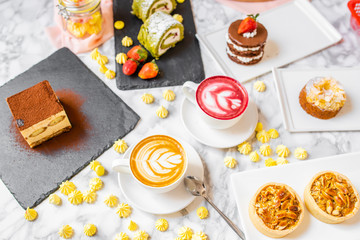delicious composition of latte tea with cakes