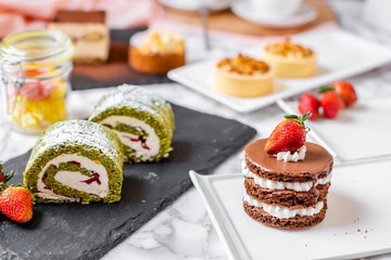 delicious strawberry and mint cakes on a white and black plate