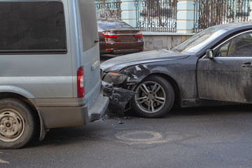 Black passenger car crashed with a broken front end