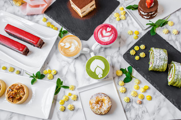 delicious composition of latte tea with cakes